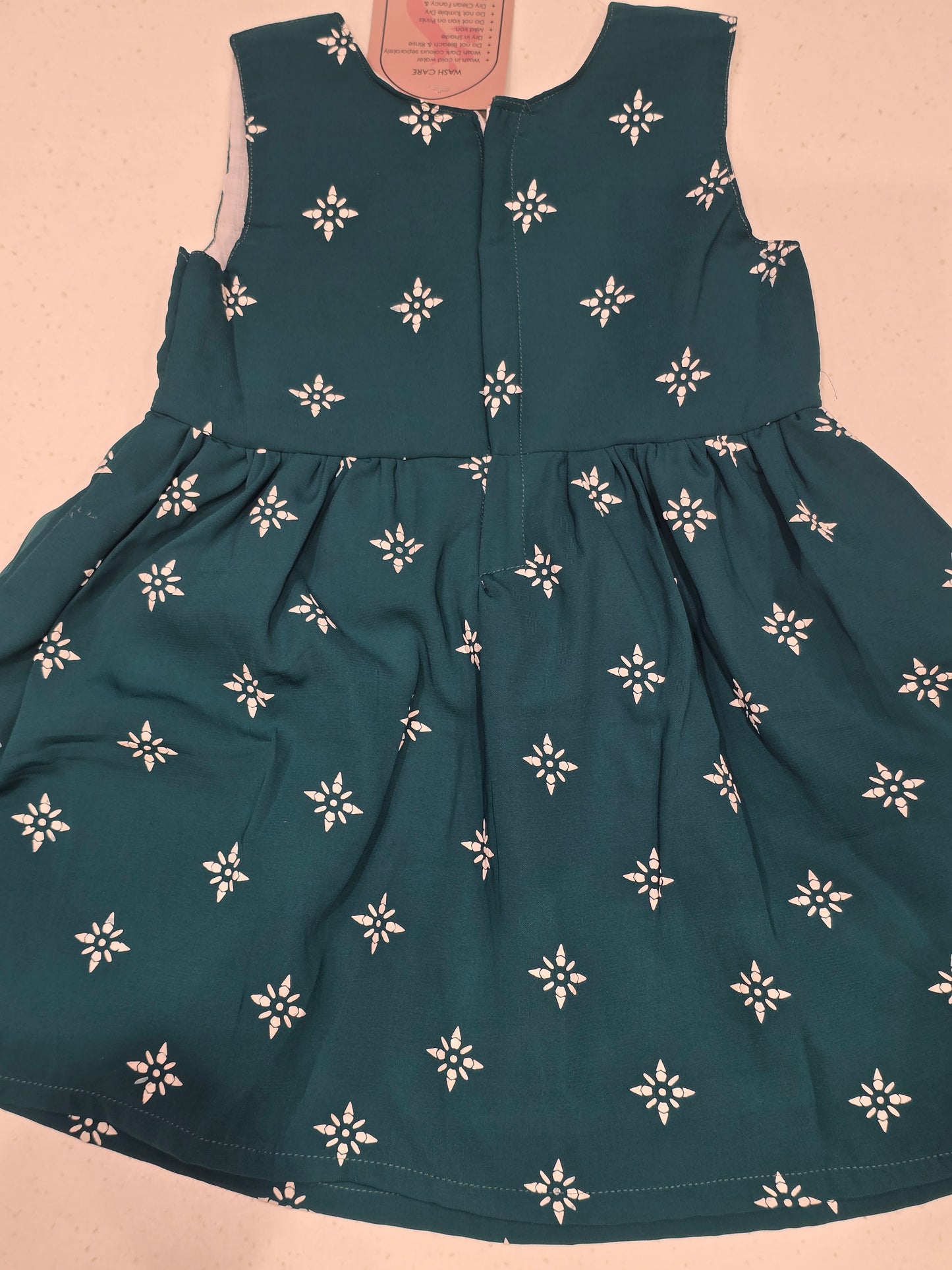Cotton material peacock blue color baby frock with round neck