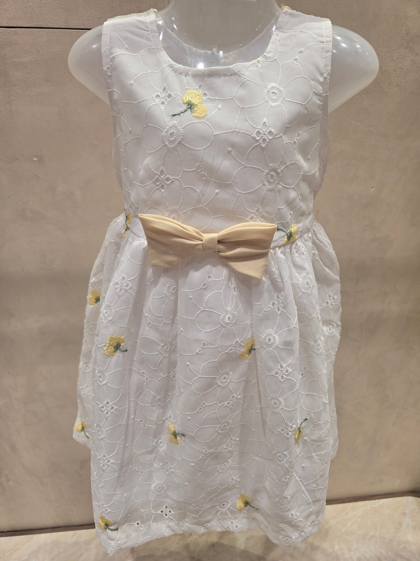 White shiffon fabric with acrobat design with waist yellow bow sleeves less casual wear