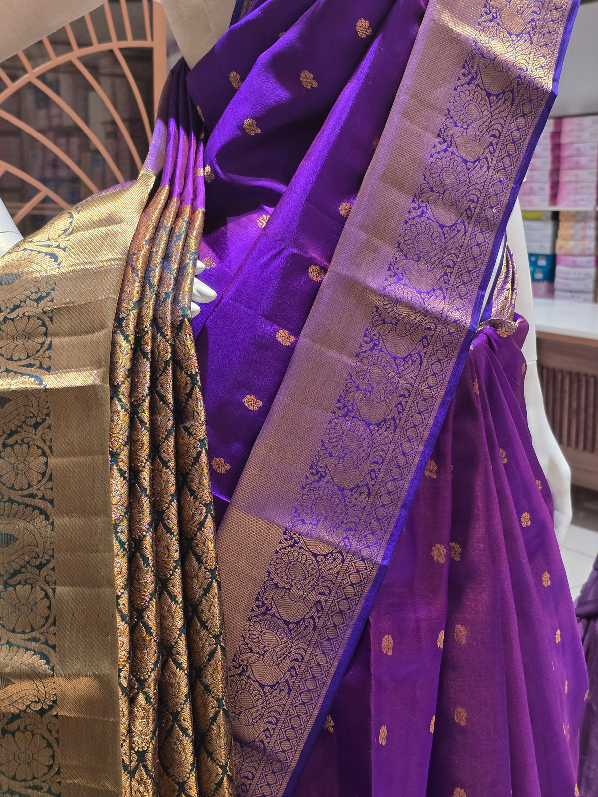 traditional Indian attire renowned for its rich color and intricate golden zari work.