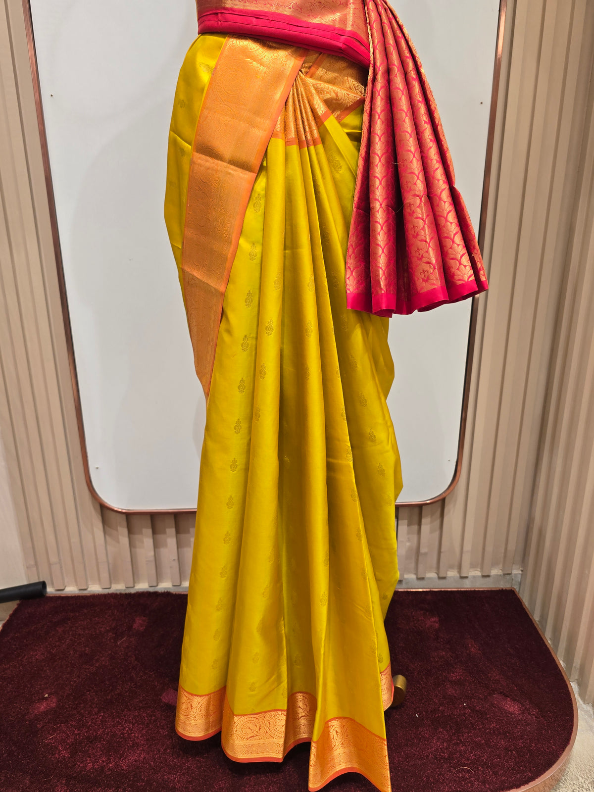 pure Kanjivaram silk saree rendered in a vibrant mustard yellow and contrasting rani pink color scheme.