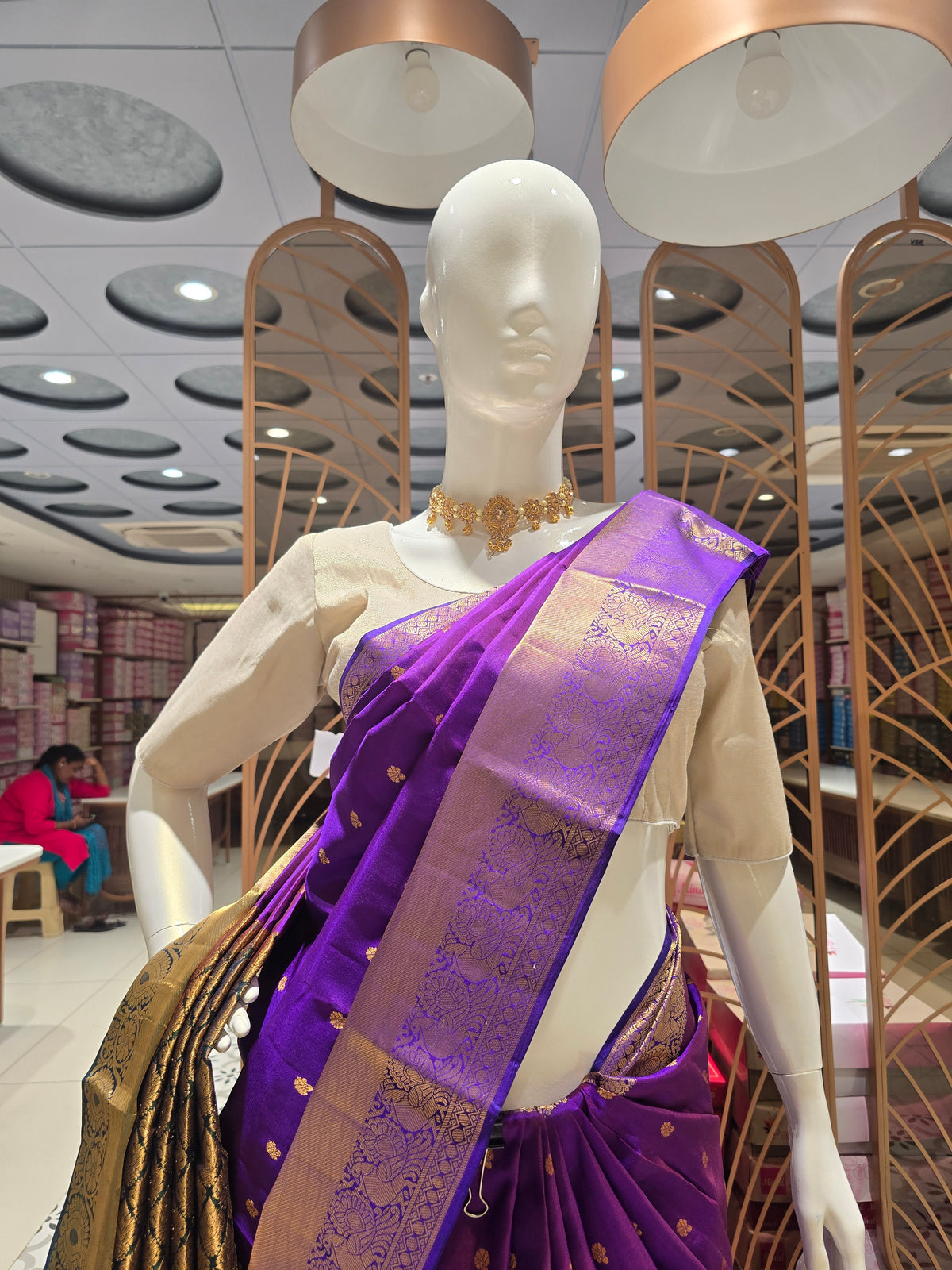 traditional Indian attire renowned for its rich color and intricate golden zari work.