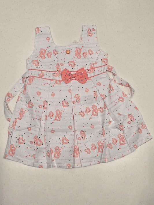 sleeveless cotton baby frock features an all-over heart print, making it perfect for everyday casual summer wear