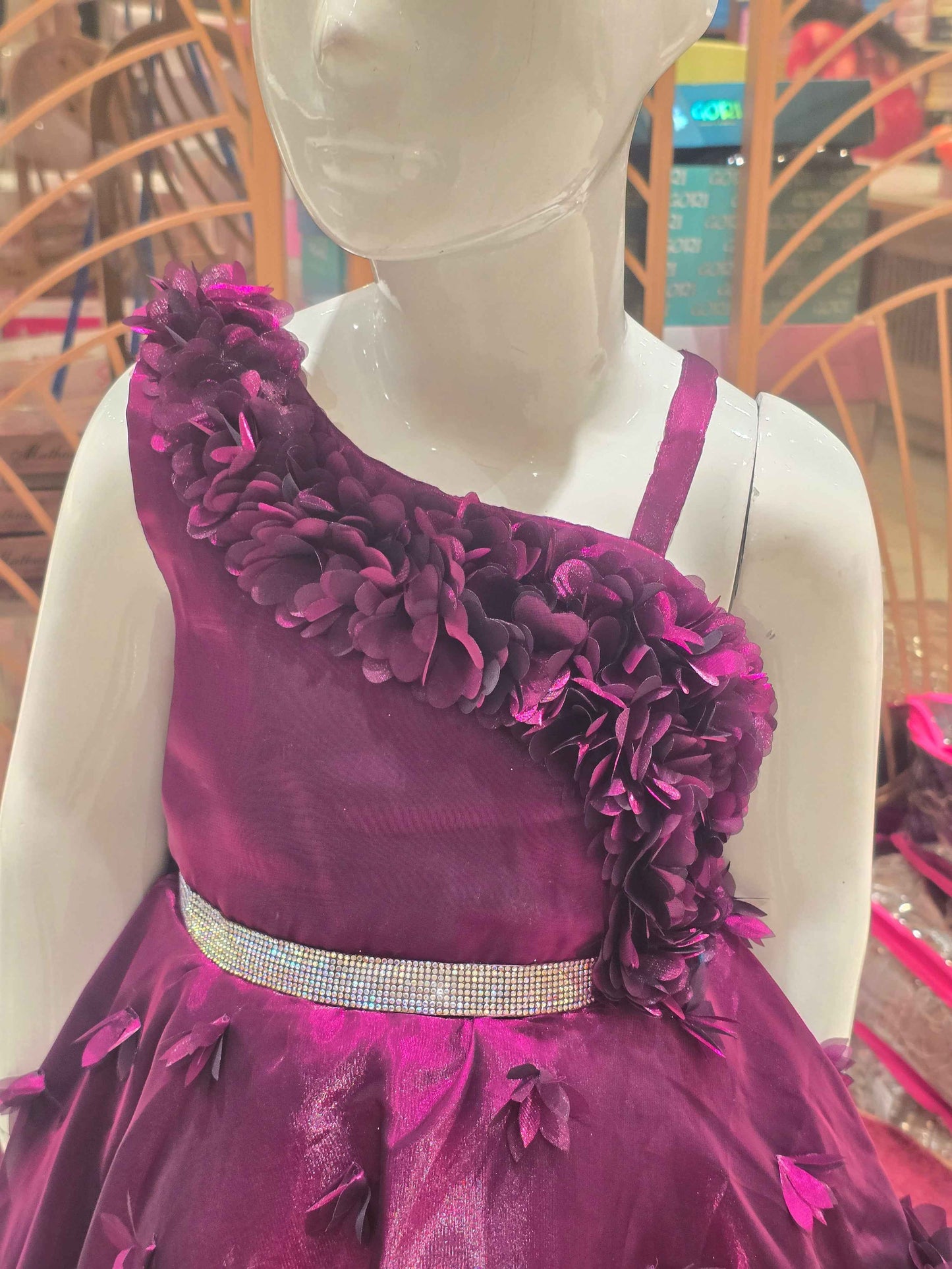 Organza material purple colour frock with flower cut design on border and bottom skirt left shoulder had speghetti with floral cut