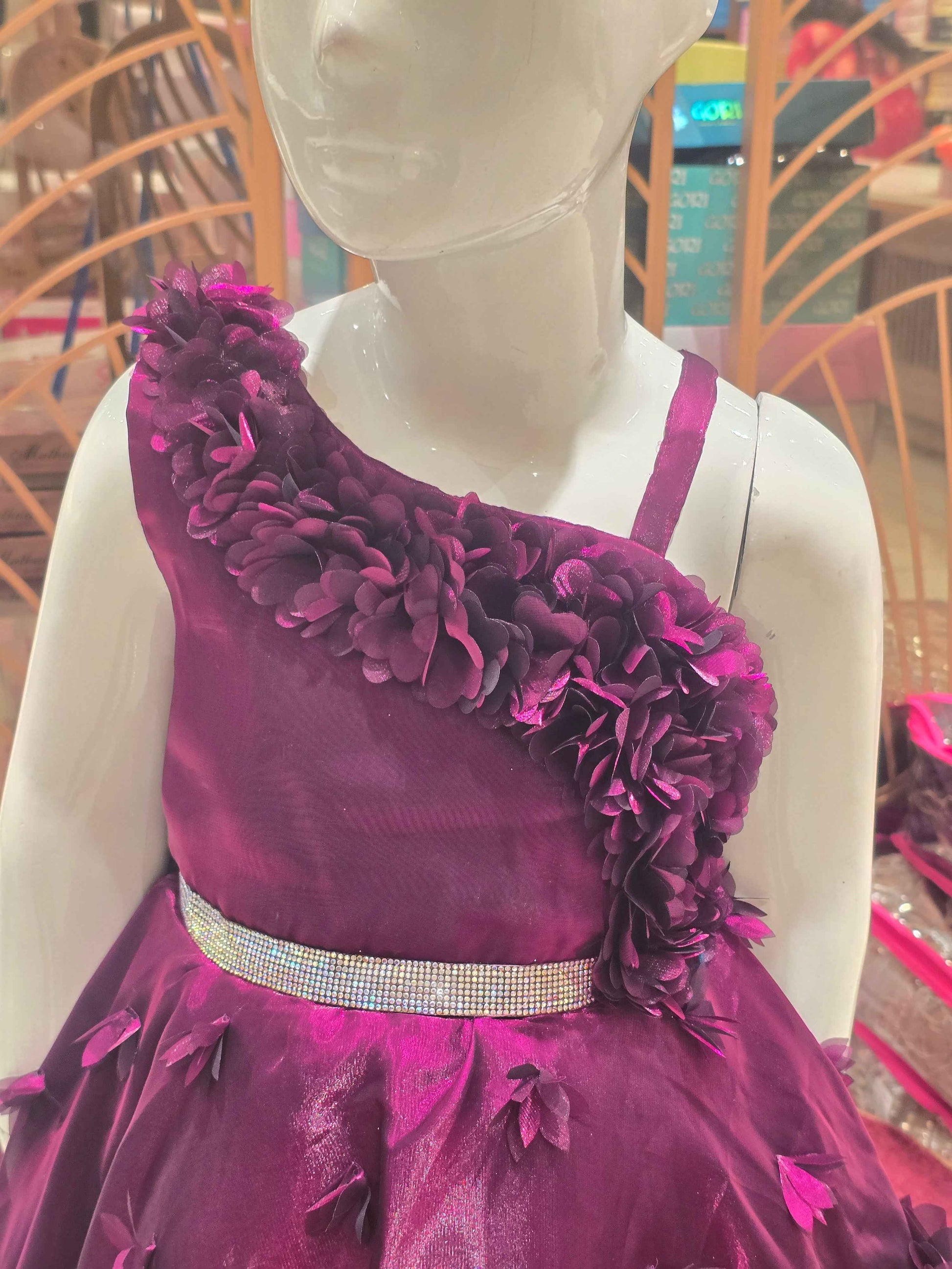 Organza material purple colour frock with flower cut design on border and bottom skirt left shoulder had speghetti with floral cut