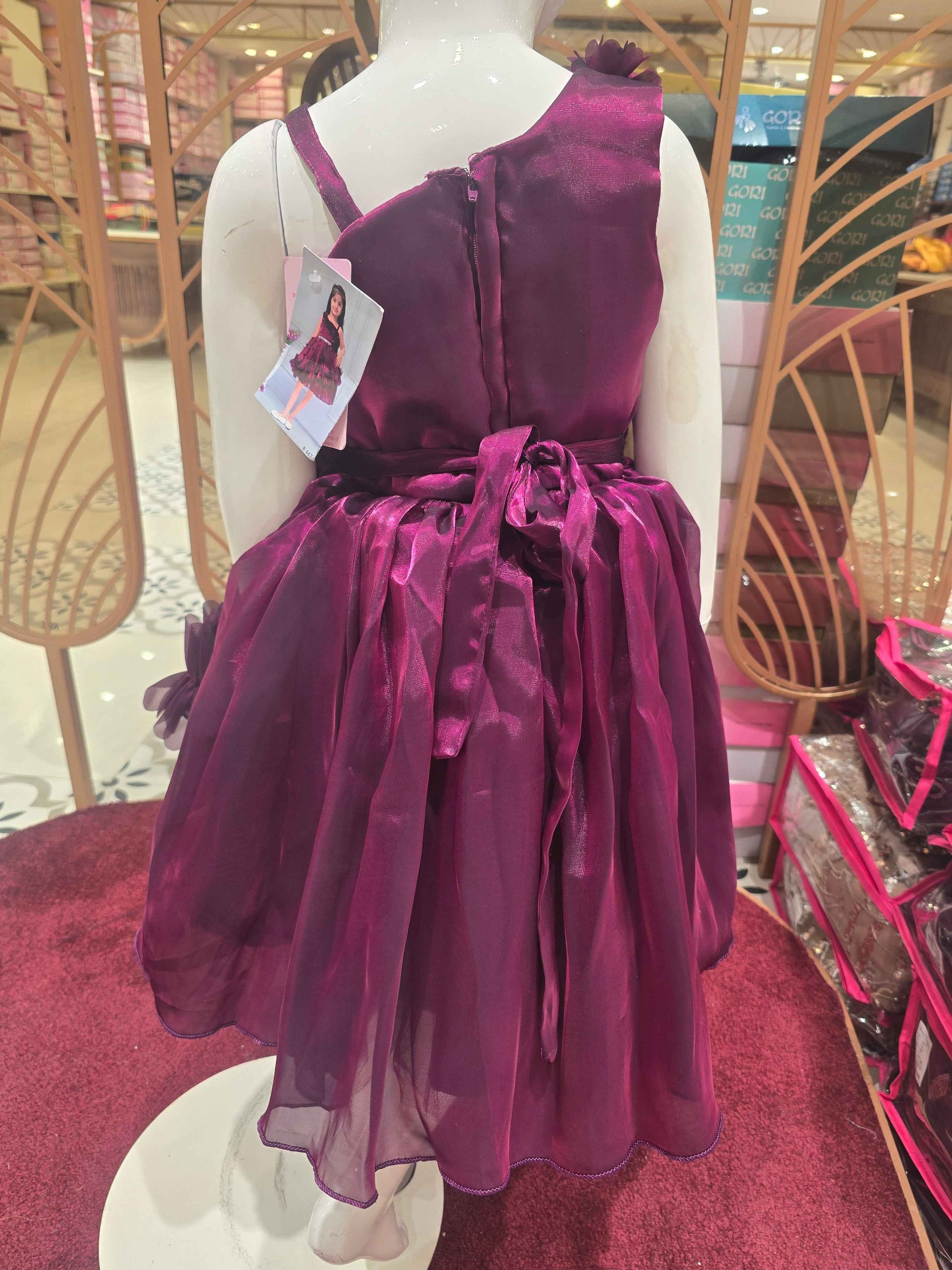 Organza material purple colour frock with flower cut design on border and bottom skirt left shoulder had speghetti with floral cut