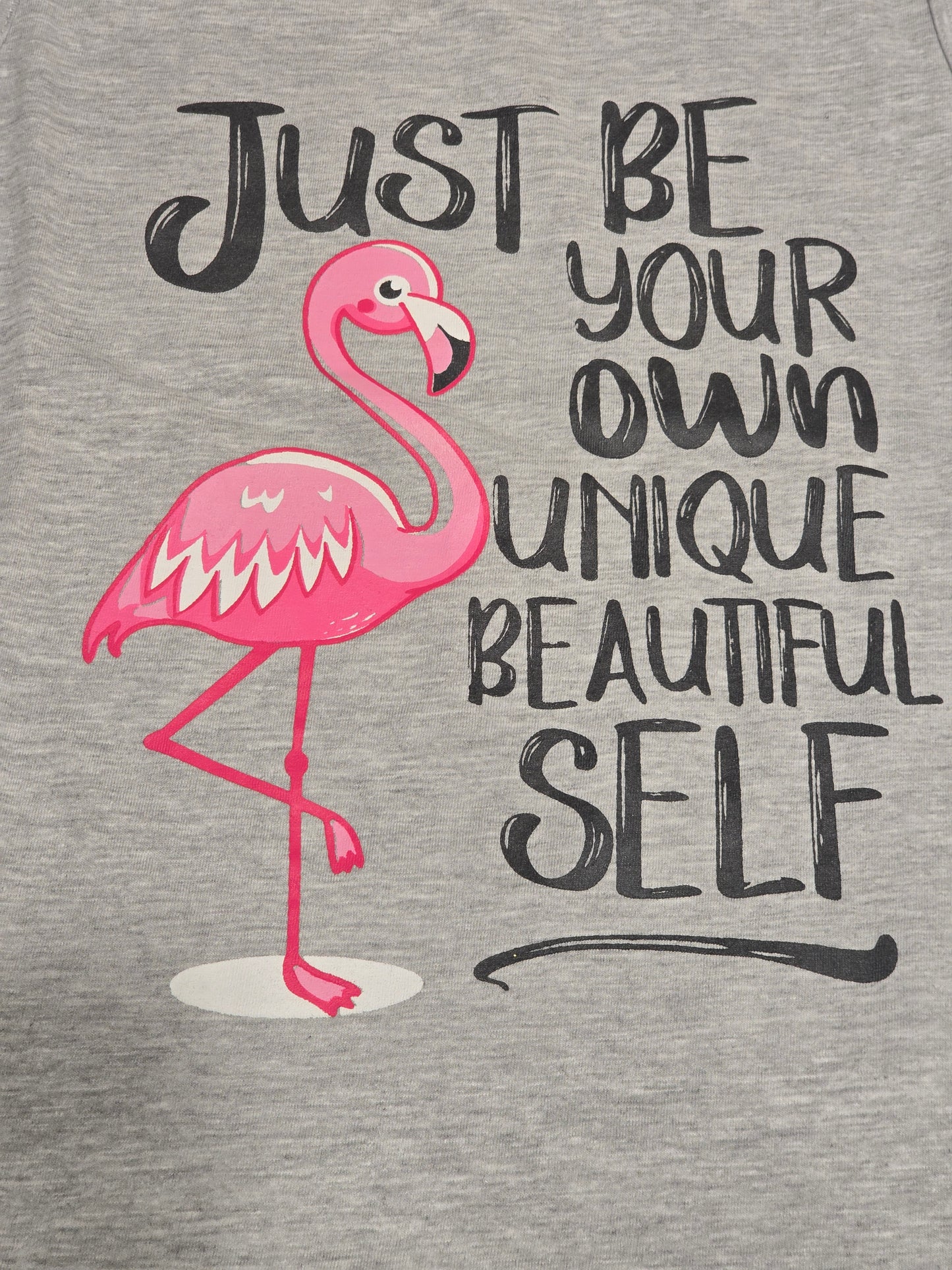 grey sleeveless graphic top or dress featuring a pink flamingo illustration alongside the motivational quote,