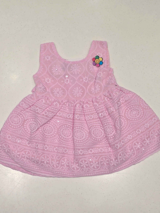 baby girl's cotton frock in a soft pastel pink shade.