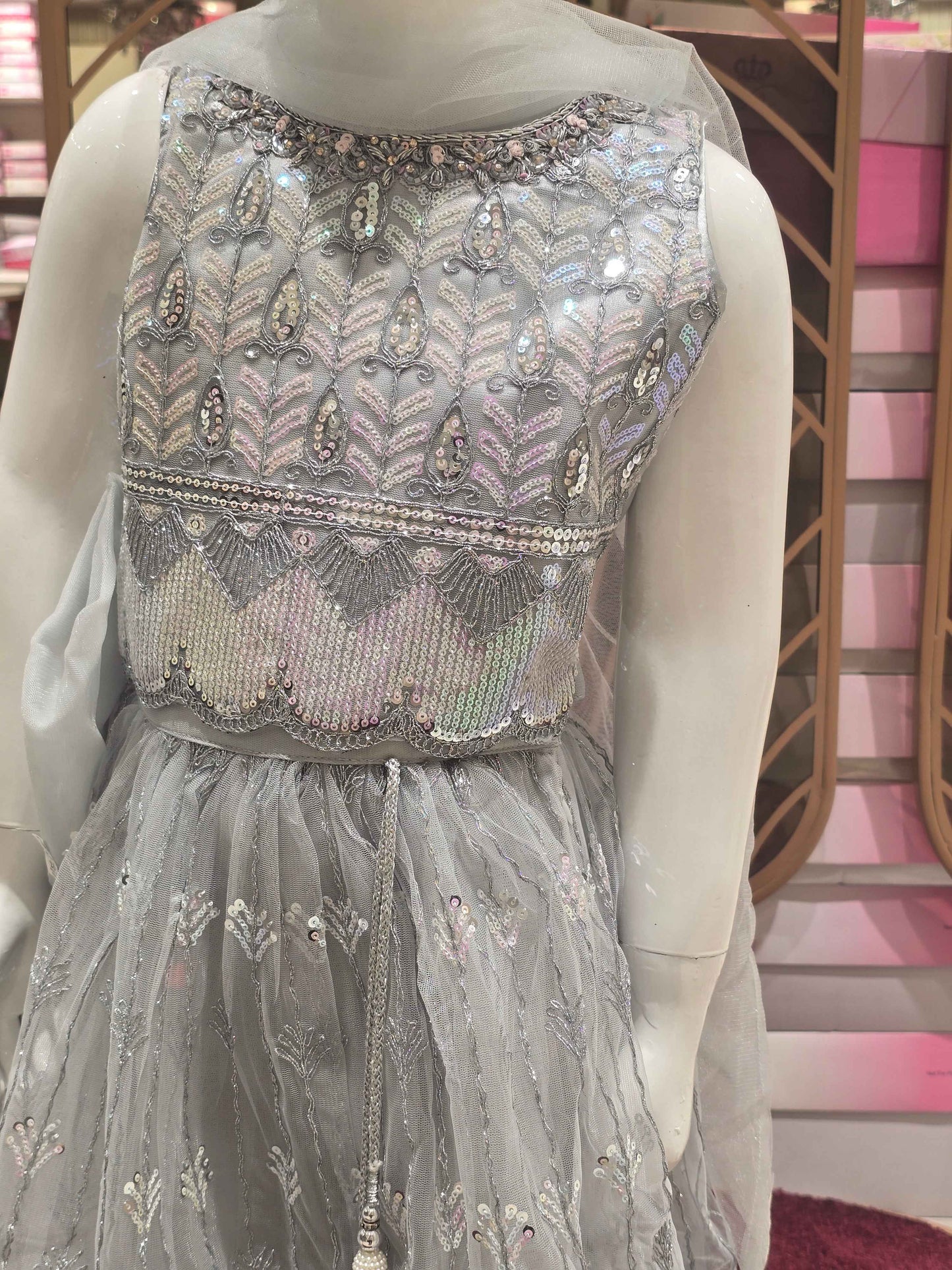 Knitted material silver colour bridal wear with sequence work over the body with silver embroidery. Dupatta with fril border