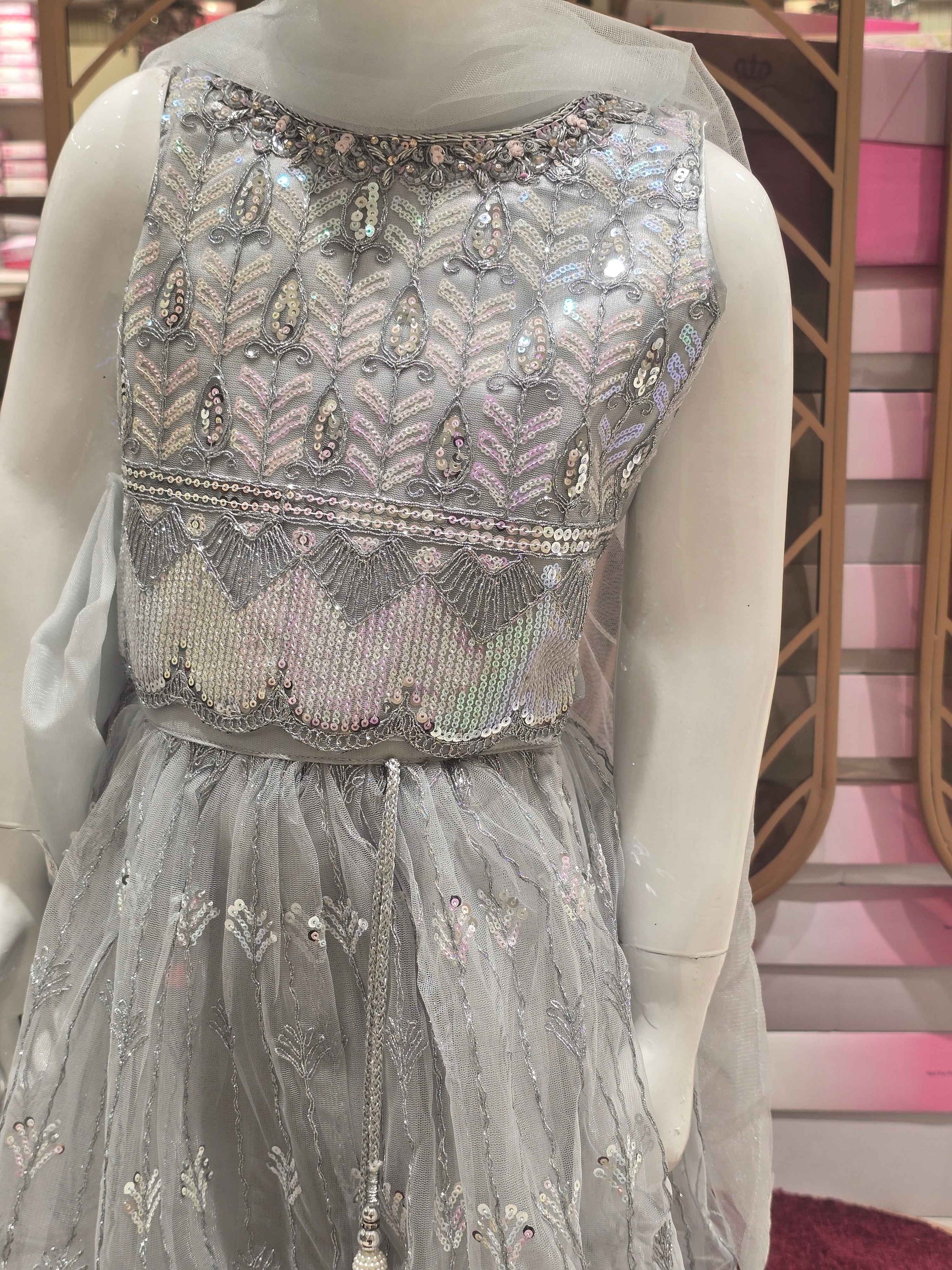 Knitted material silver colour bridal wear with sequence work over the body with silver embroidery. Dupatta with fril border