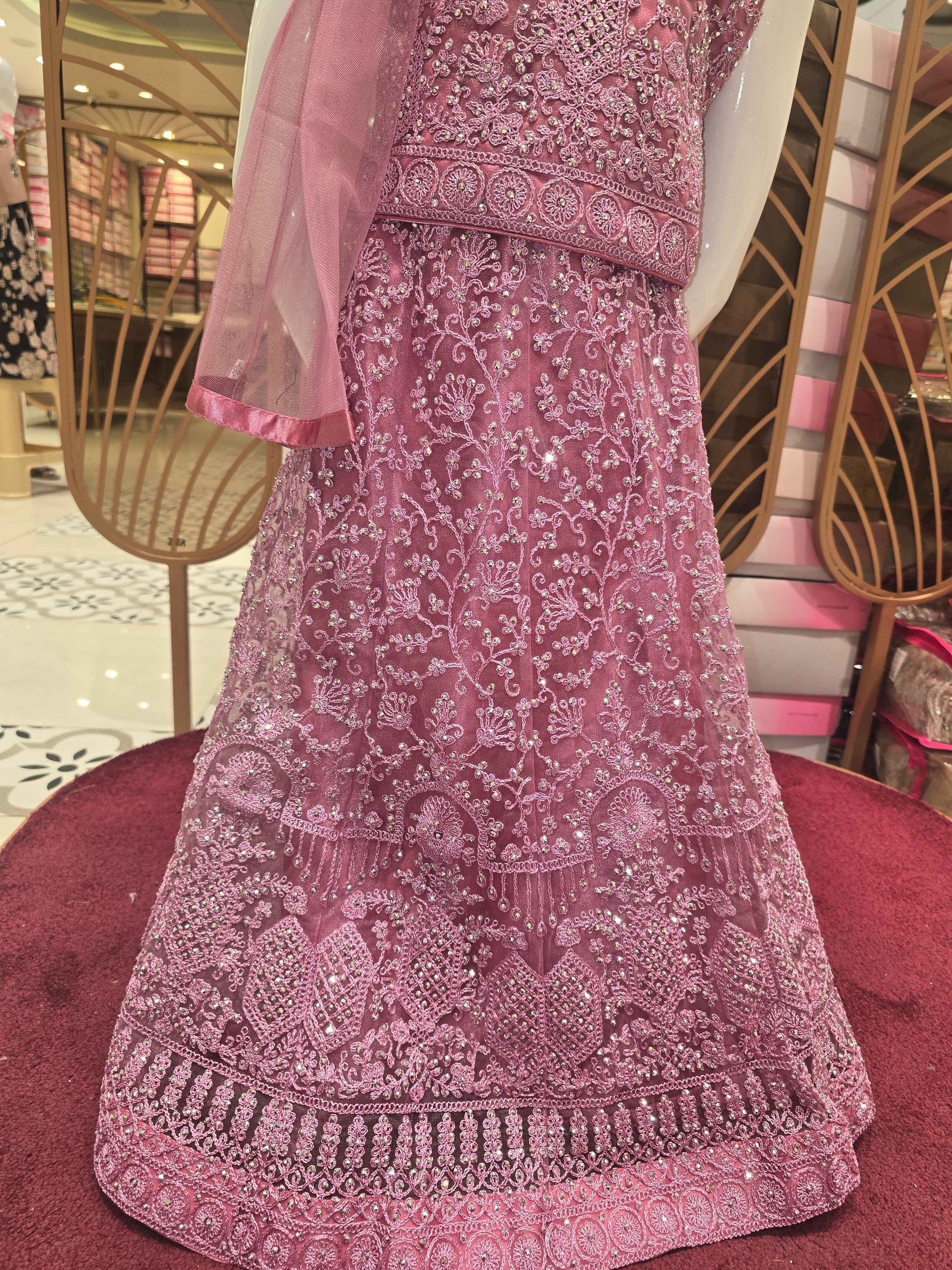 Knitted materail onion pink colour gaghra choli. Embroidery with stone fancy work on front side with round neck