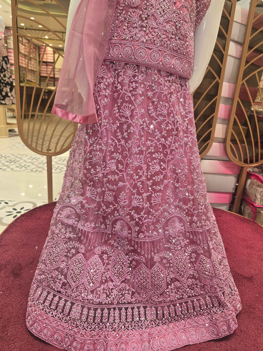 Knitted materail onion pink colour gaghra choli. Embroidery with stone fancy work on front side with round neck