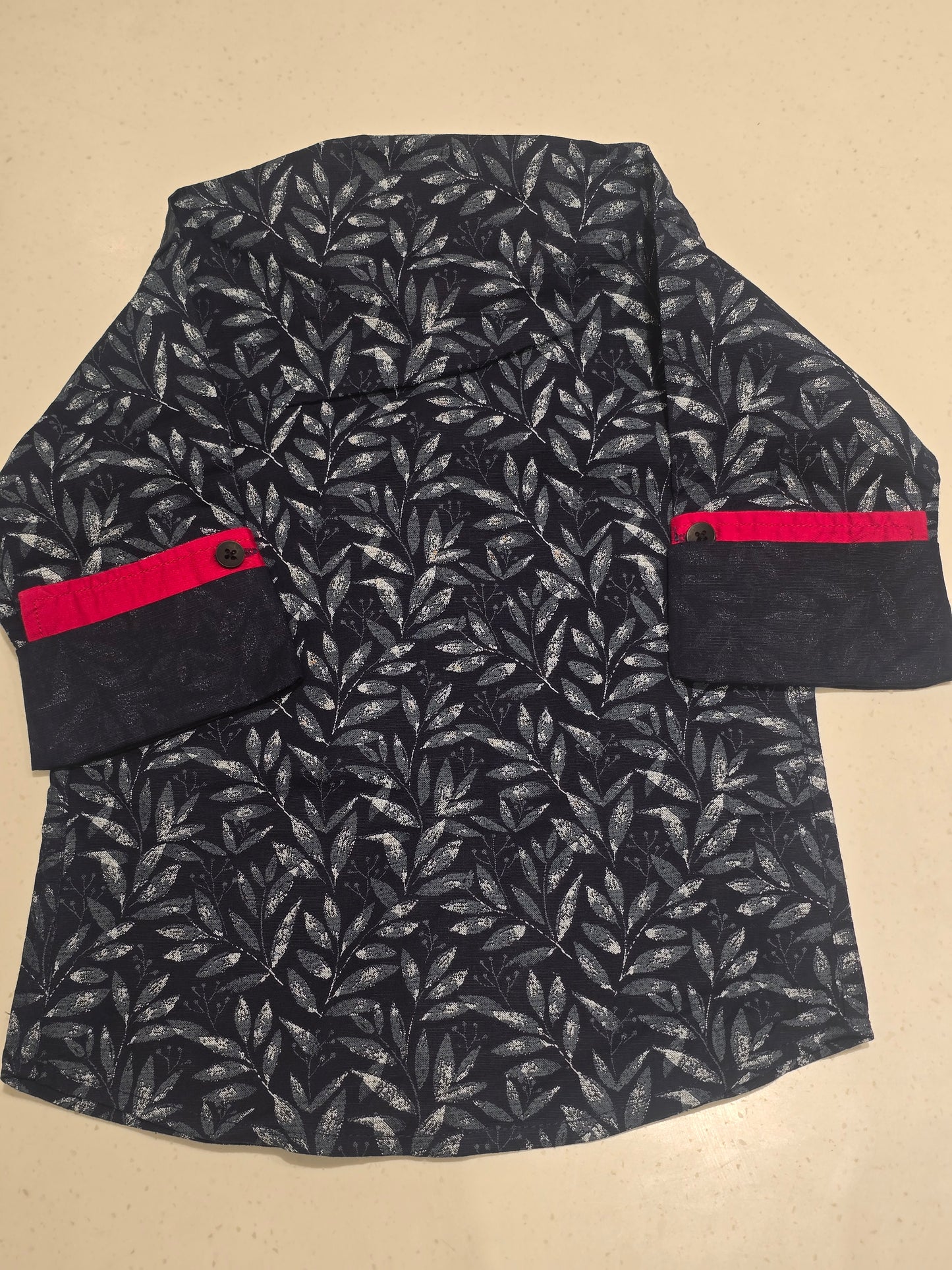 Printed cotton material blue color shirt with red color piping for sleeves & neck