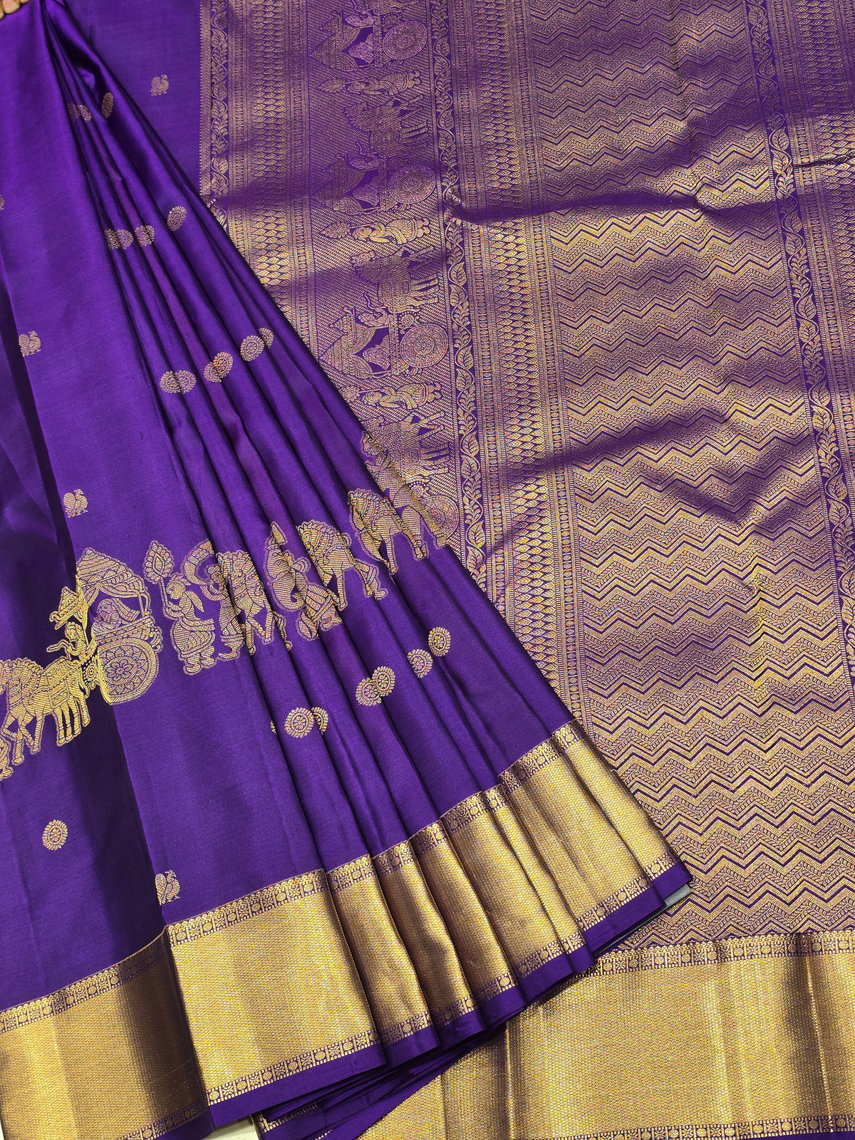 One saree is a deep royal purple, and the other is a rich magenta/wine tone.