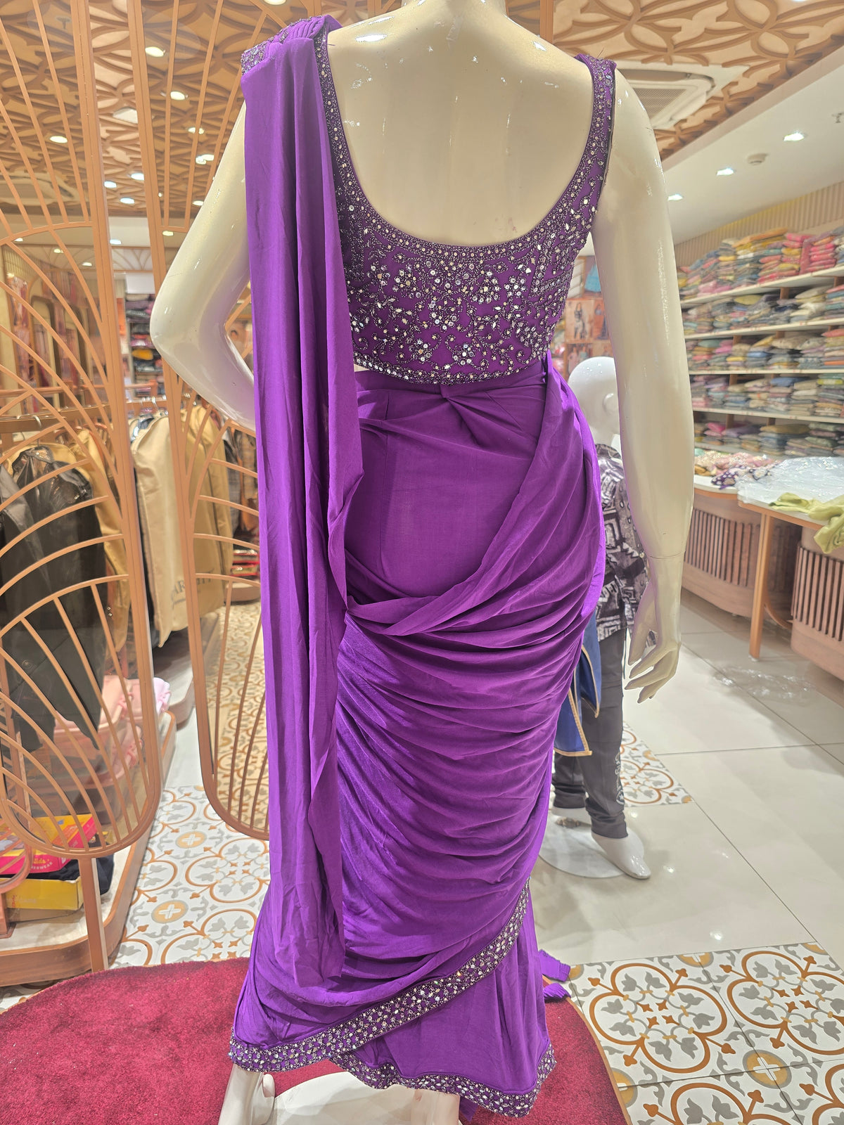 purple ready-to-wear pre-stitched saree crafted with a sleek, draping fabric like Lycra or satin crepe.