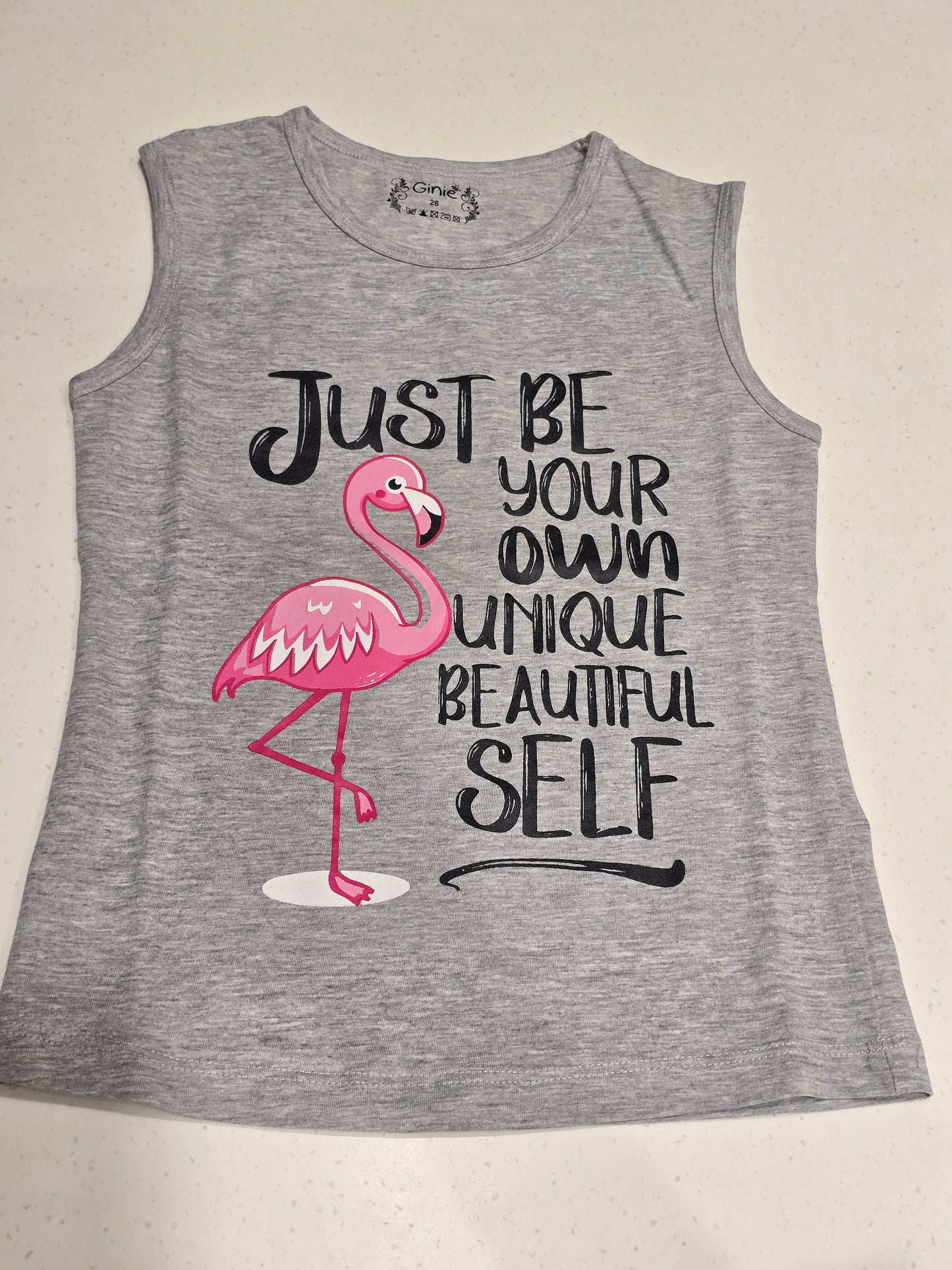 grey sleeveless graphic top or dress featuring a pink flamingo illustration alongside the motivational quote,
