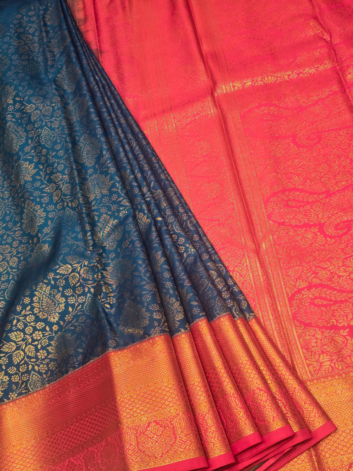 royal blue and rani pink semi-silk saree featuring rich gold zari brocade weaving.