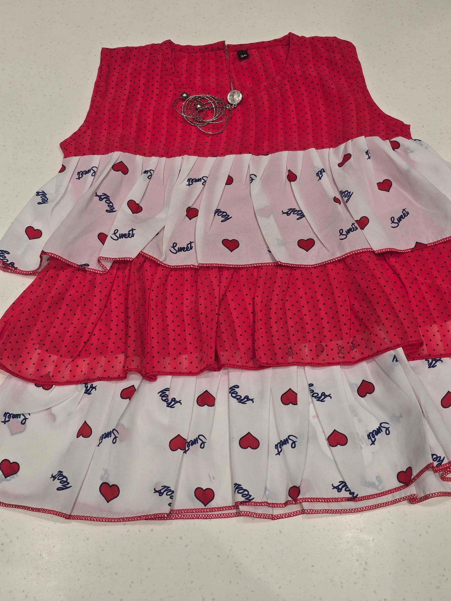 kids' tiered frill dress featuring alternating horizontal layers of patterned fabric.