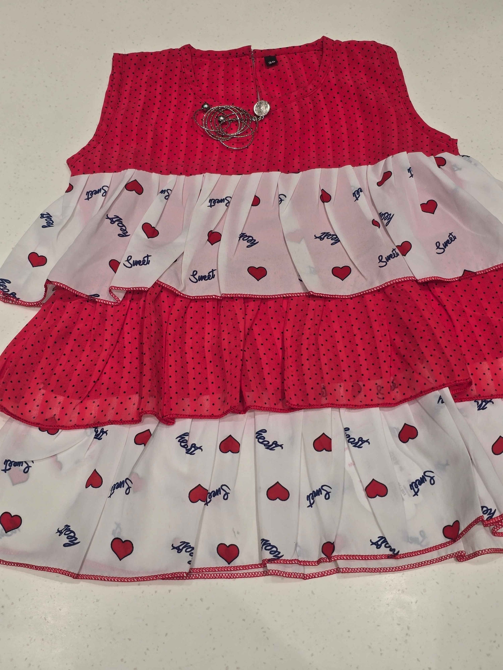 kids' tiered frill dress featuring alternating horizontal layers of patterned fabric.