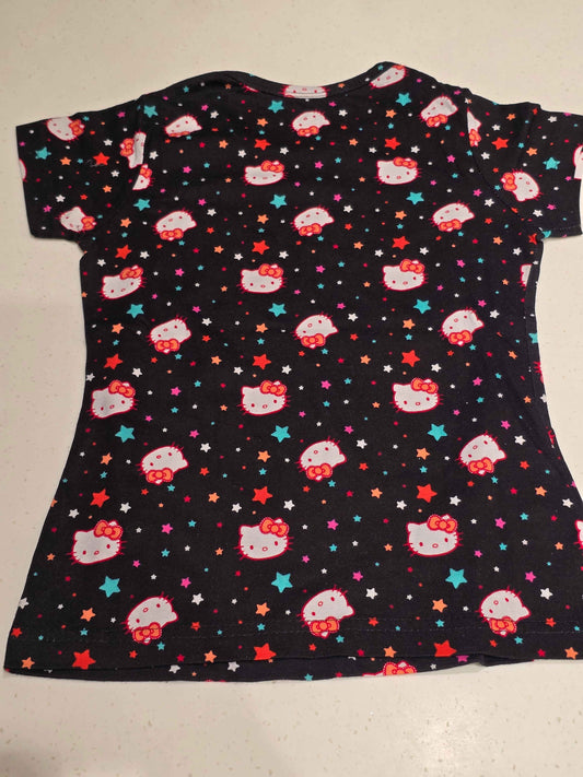 black Hello Kitty t-shirt / short night dress decorated with an all-over repeating print of Hello Kitty faces and multi-colored stars.